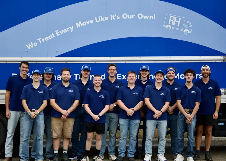 The full RiverHills Moving crew in matching navy polos and branded caps