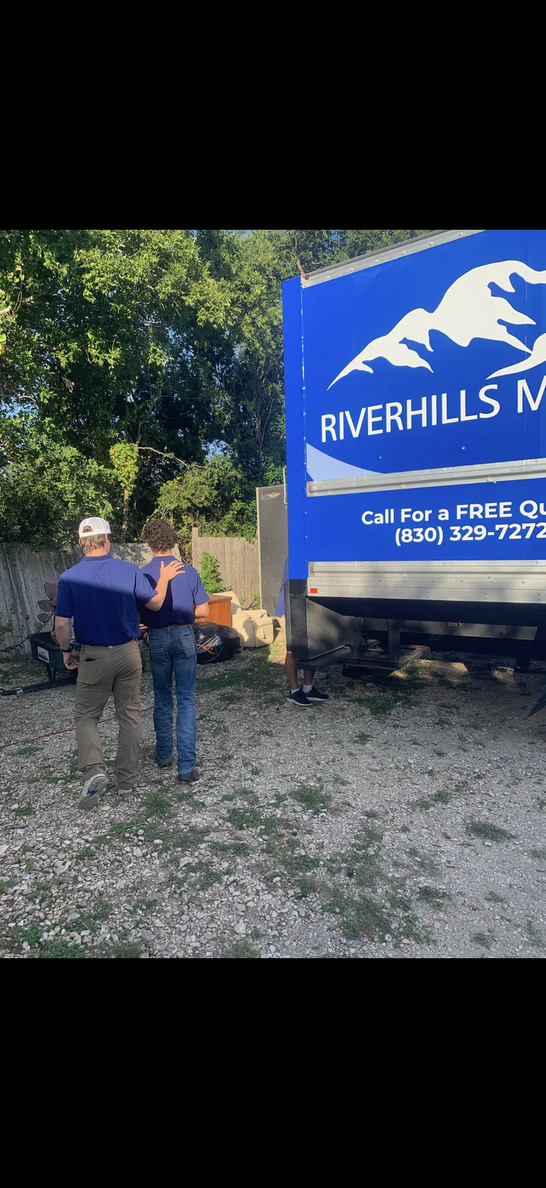 RiverHills Moving crew beside the company box truck